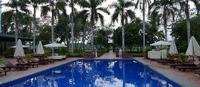 Miami Florida golf resort swimming pool reflecting royal palm trees on surface water